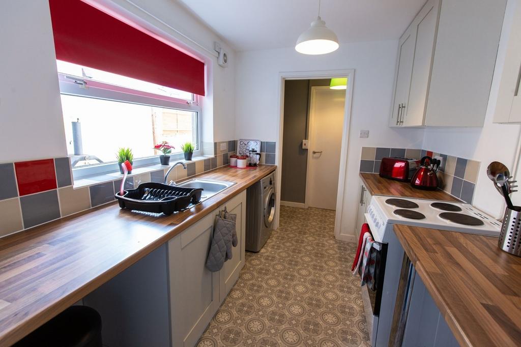 A clean and bright kitchen with modern applianc...