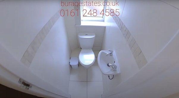Bright and clean single toilet featuring modern...