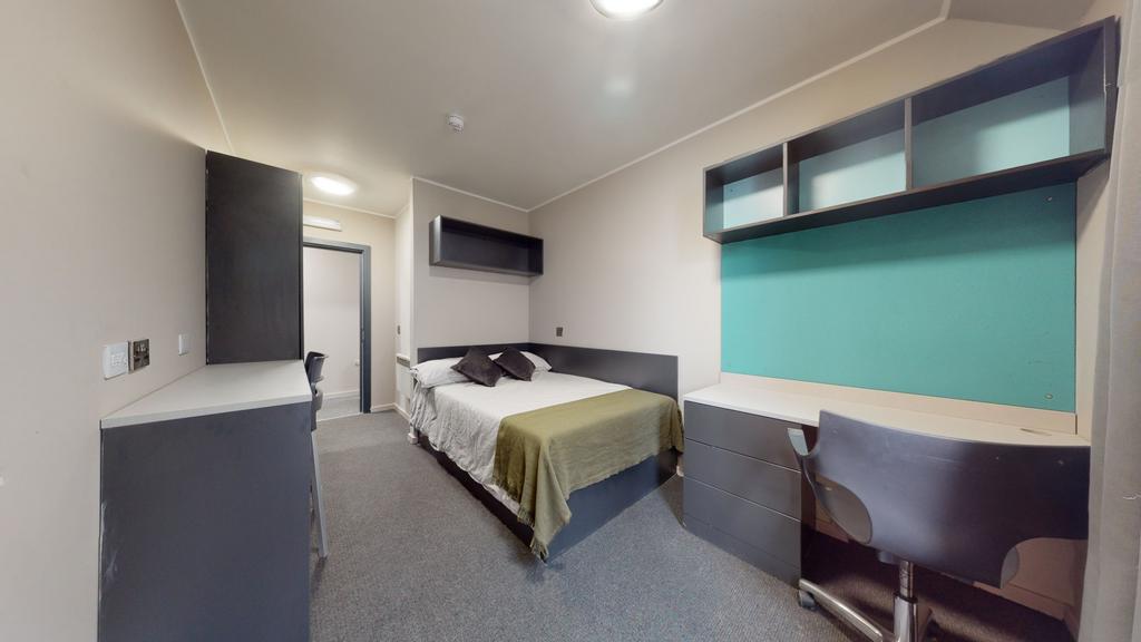 A well-maintained bedroom featuring a comfortab...