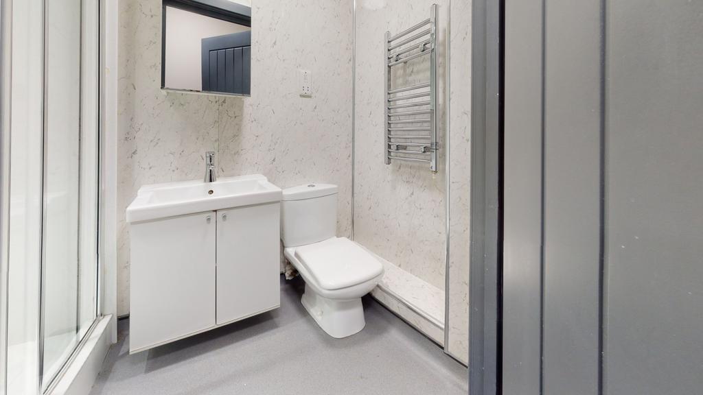 A modern, clean bathroom featuring a white toil...