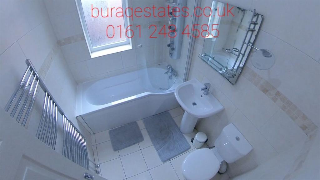 Bright, modern bathroom with a bathtub, overhea...