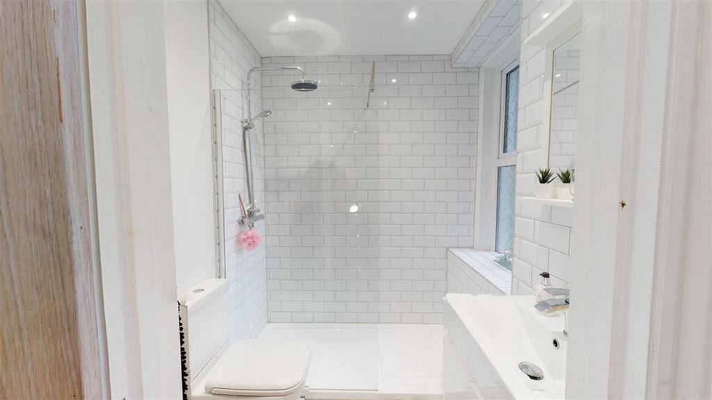 A bright and modern bathroom featuring a spacio...
