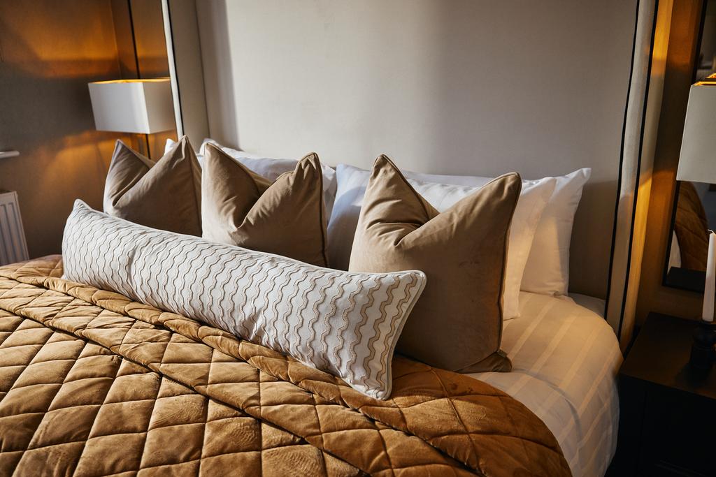 Close up of pillows on bed against modern...