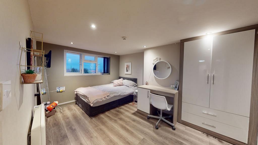 A bright and spacious double bedroom featuring ...