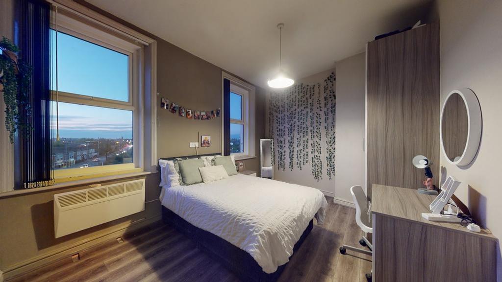 A spacious and bright double bedroom featuring ...