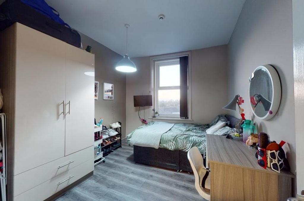 A bright and inviting double bedroom featuring ...