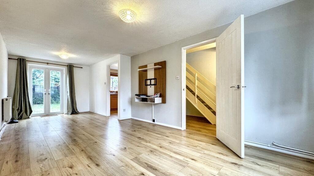 Bright and spacious living room featuring light...