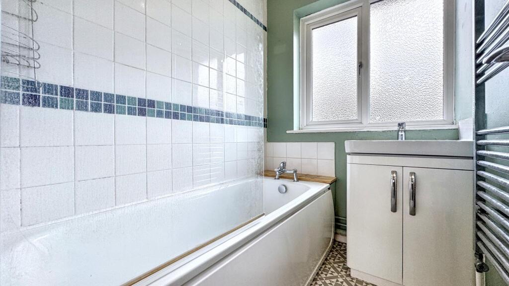 Bright and clean bathroom featuring a full-size...