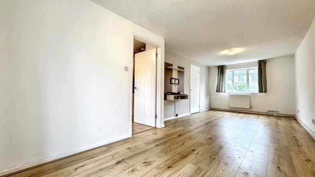 Bright and spacious living room featuring conte...