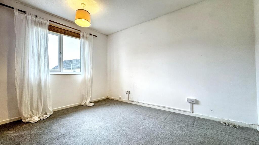 A bright and clean double bedroom featuring a l...
