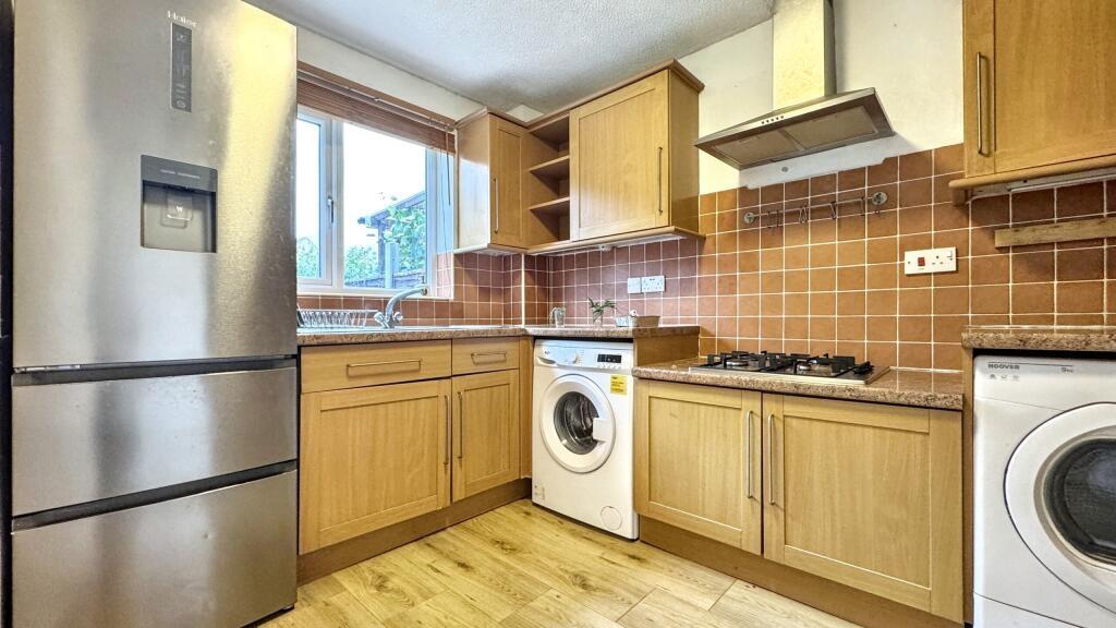 A bright and functional kitchen with ample wood...