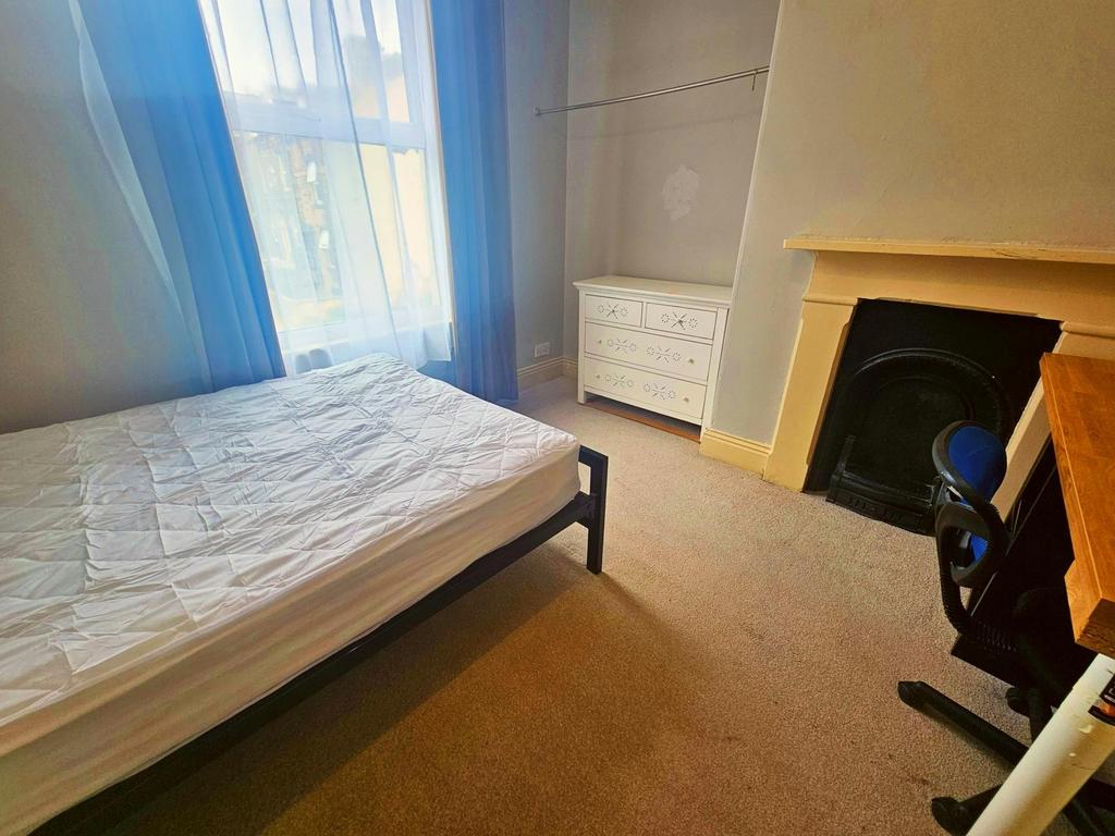 A bright and inviting bedroom featuring a neatl...