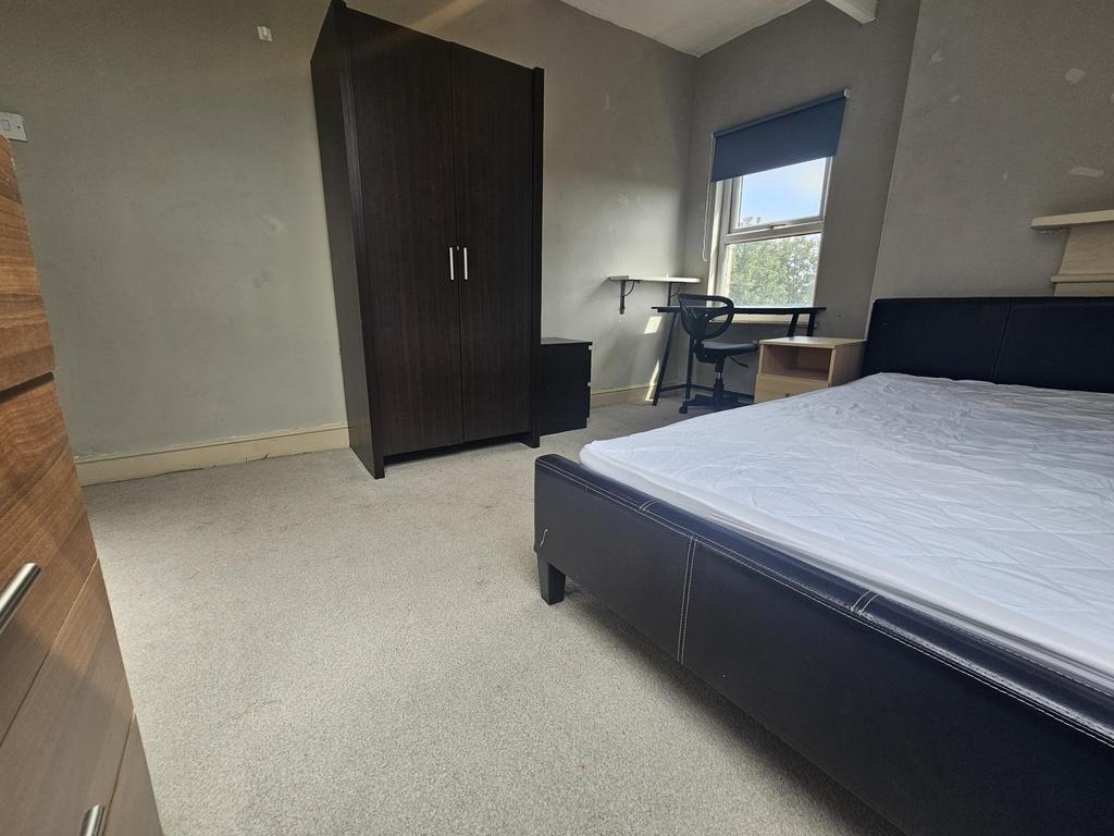 A well-maintained student bedroom featuring a c...