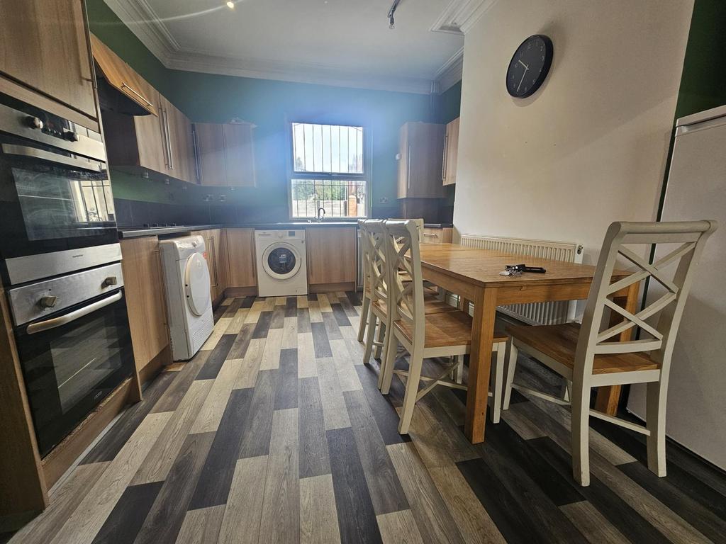 A modern kitchen area featuring a wooden dining...