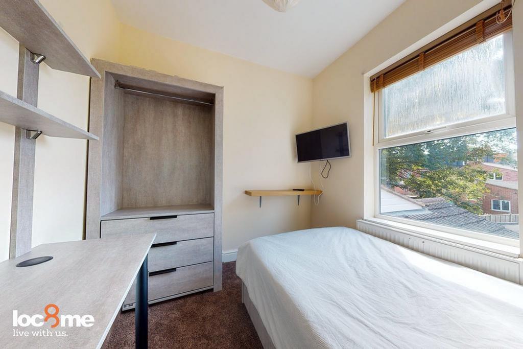 A bright and inviting double bedroom featuring ...