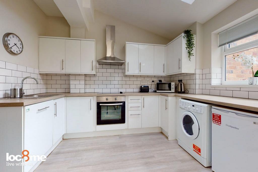 A bright and modern kitchen featuring sleek cab...