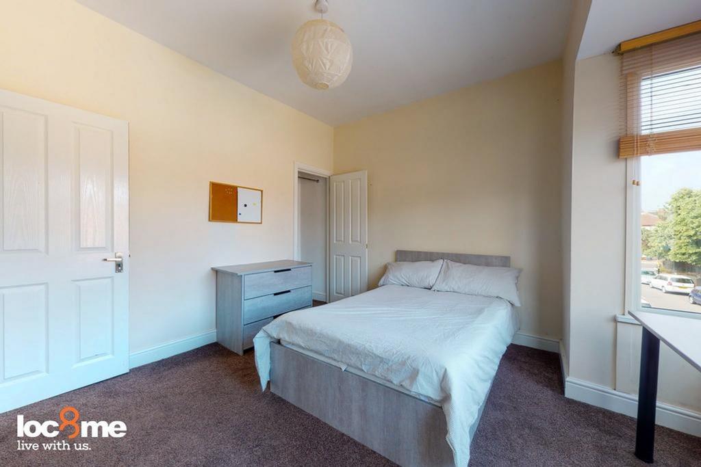 A bright and inviting double bedroom with ample...