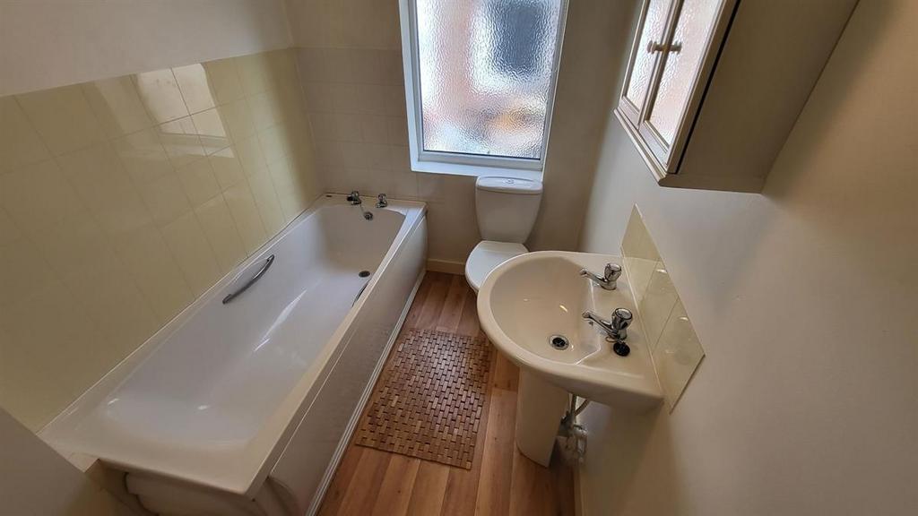 A bright and clean bathroom featuring a spaciou...