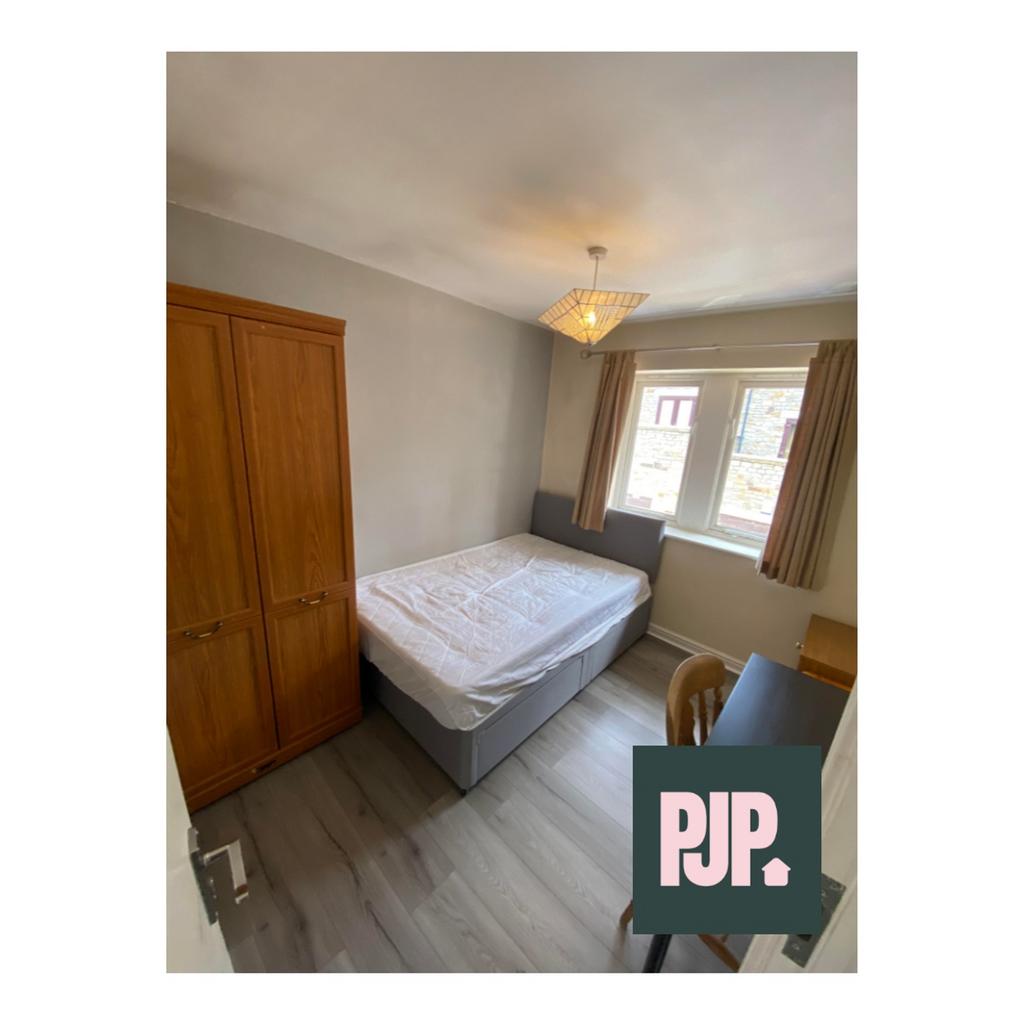 A cozy double bedroom featuring ample natural l...