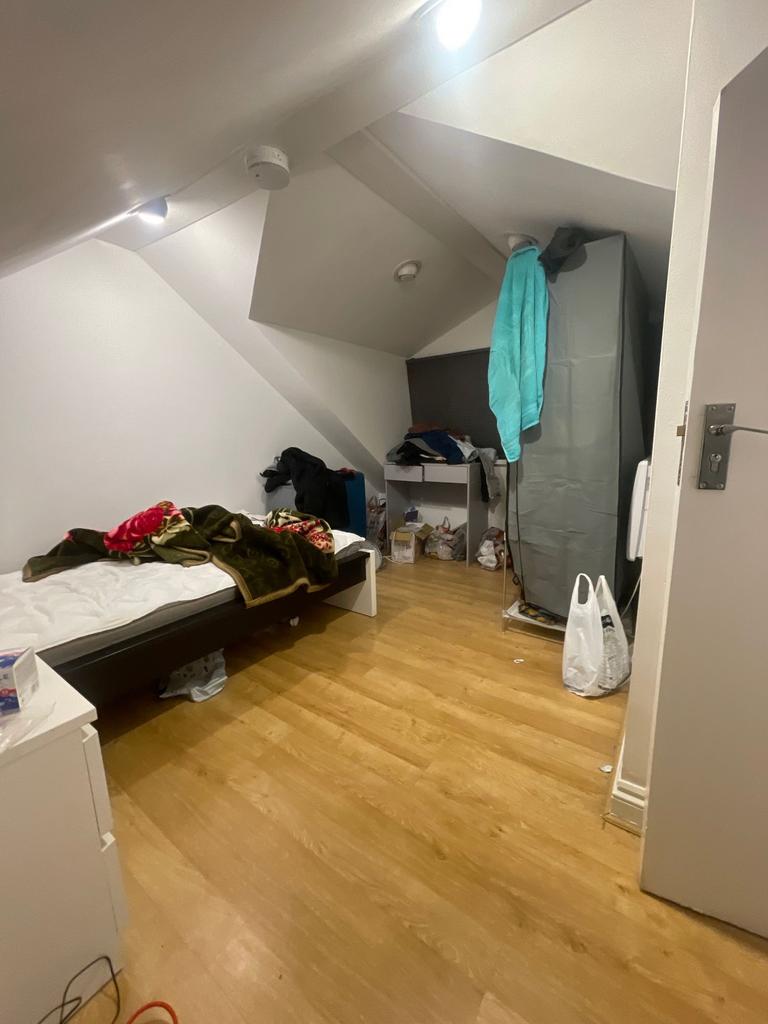 Cozy attic-style bedroom with sloped ceilings, ...