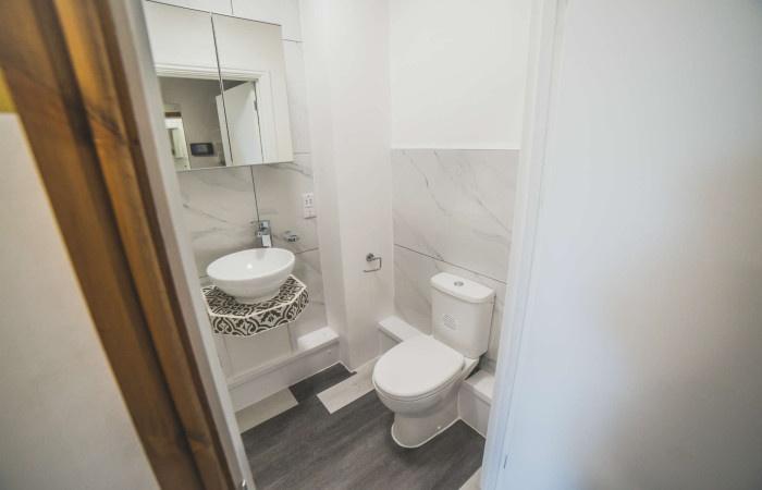 Bright and modern toilet area featuring a styli...
