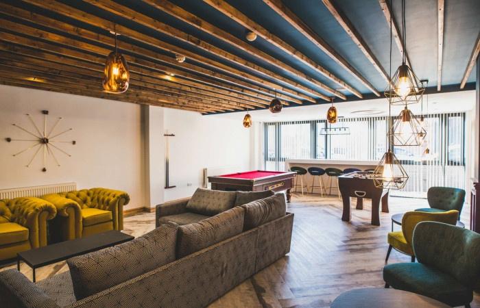 A stylish communal lounge featuring comfortable...