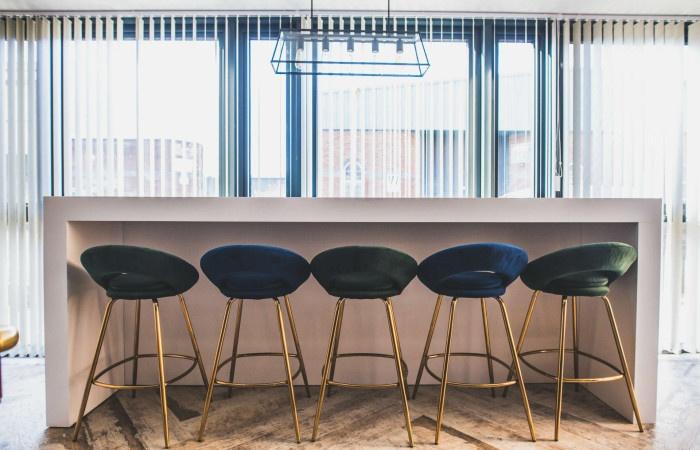 Bright and modern communal workspace featuring ...