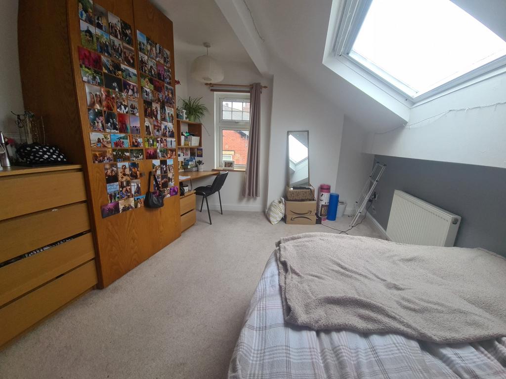 A bright and cozy master bedroom featuring a la...