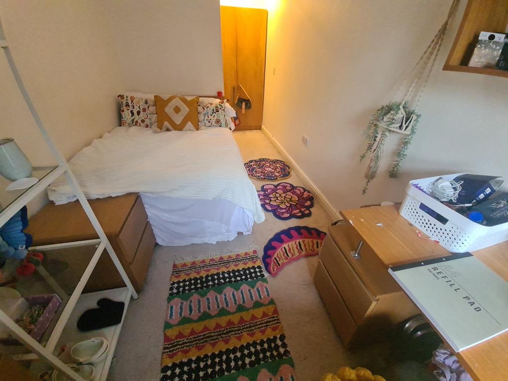 Cozy single bedroom featuring a comfortable bed...