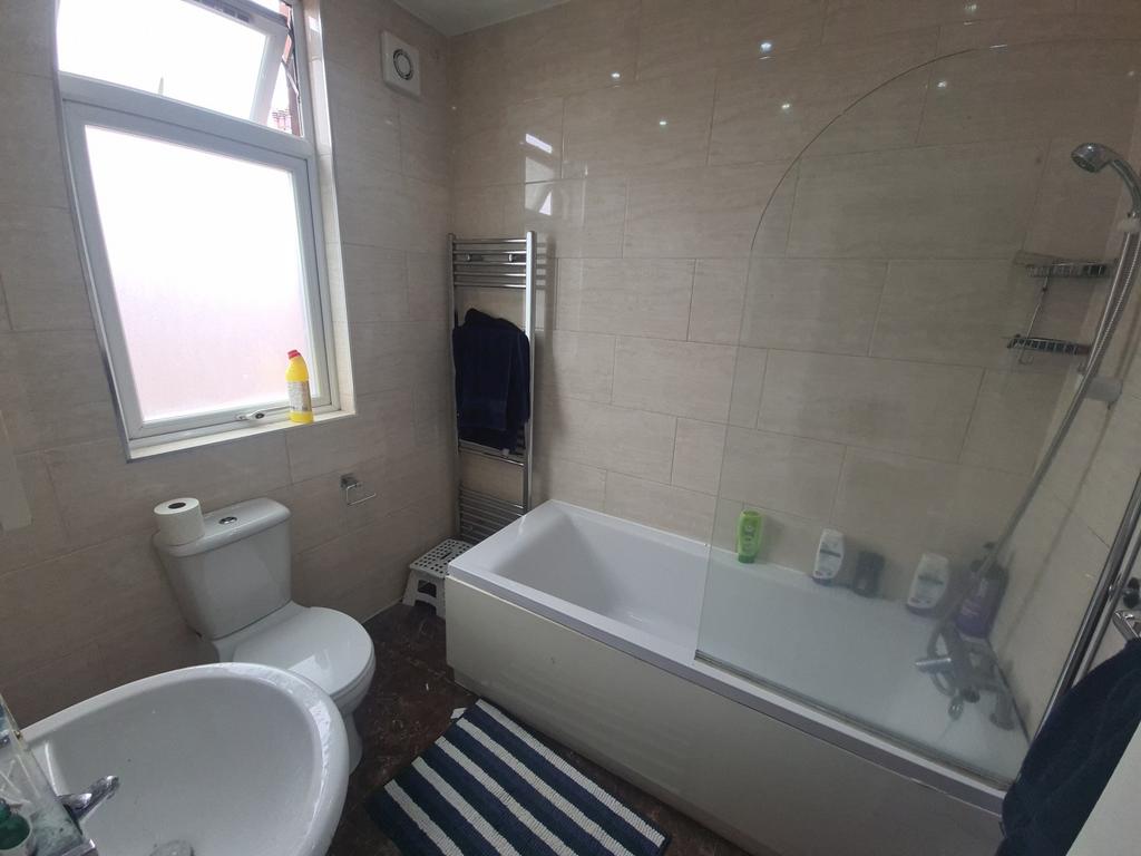 A modern bathroom featuring a full-size bathtub...