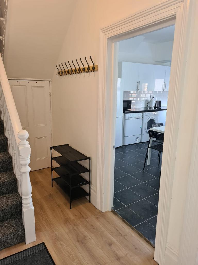 Bright and tidy hallway featuring light wooden ...