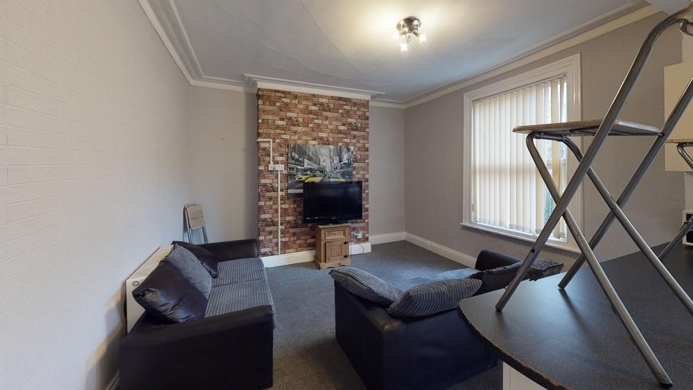 A cozy living room featuring a stylish exposed ...