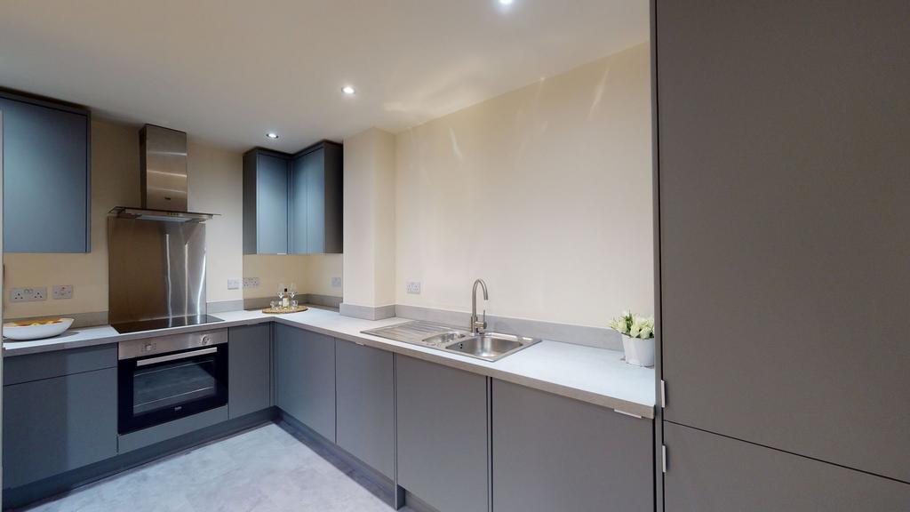 A modern kitchen featuring sleek gray cabinets,...