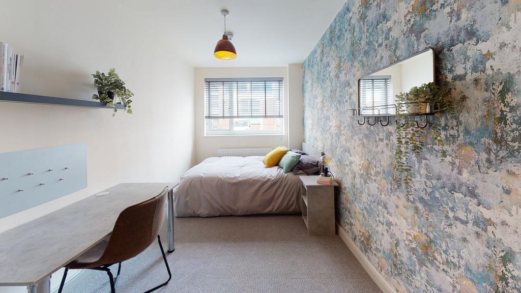Bright and welcoming bedroom featuring a comfor...