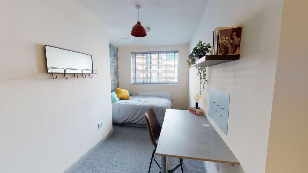 A bright, well-maintained master bedroom featur...
