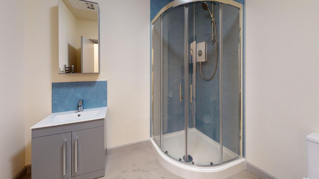A clean and modern bathroom featuring a corner ...