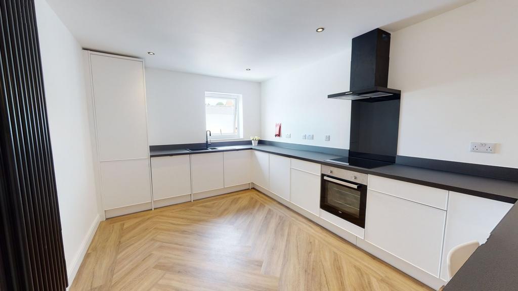 Modern, bright kitchen with sleek white cabinet...
