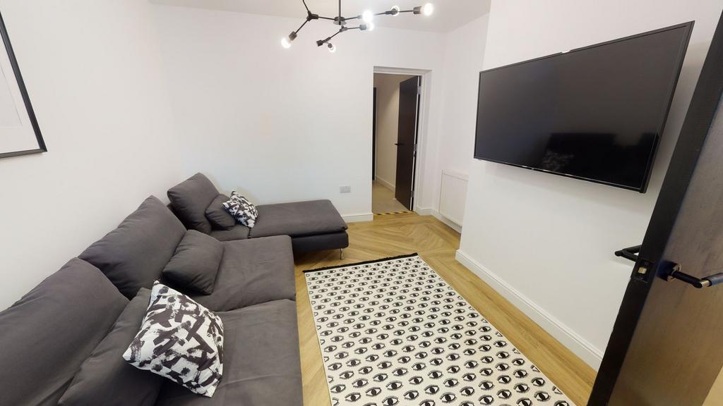 A bright and modern living room featuring a lar...