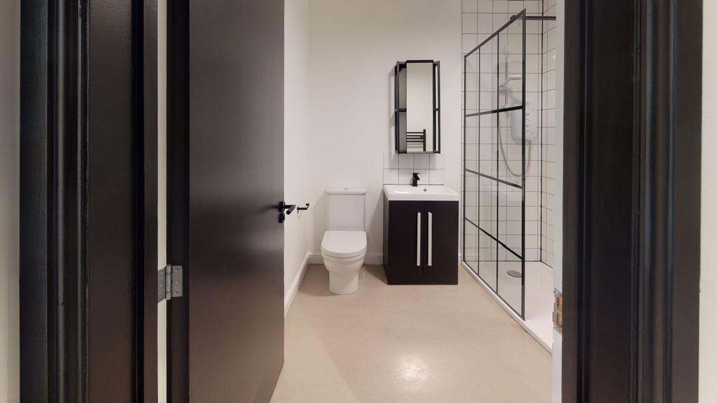 Modern bathroom featuring a white toilet, a sle...