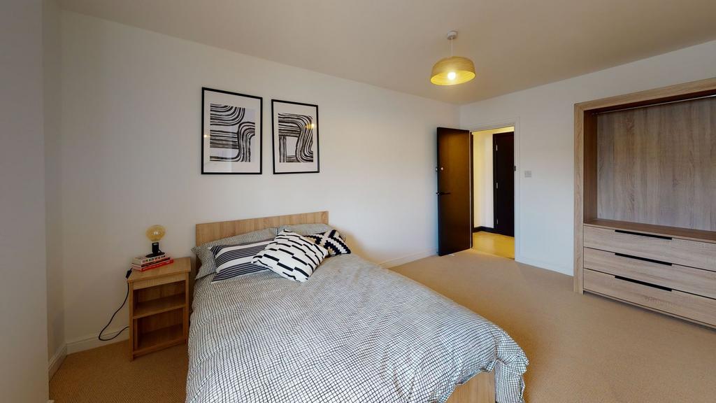 A spacious, well-maintained master bedroom feat...