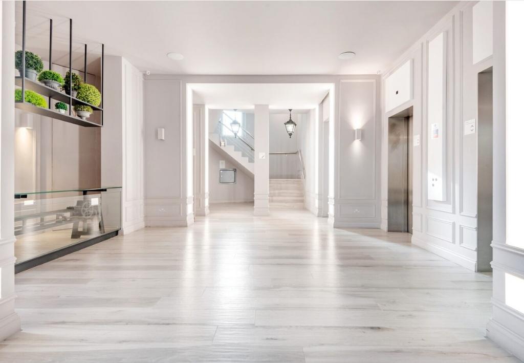 A spacious and well-lit hallway with modern dec...