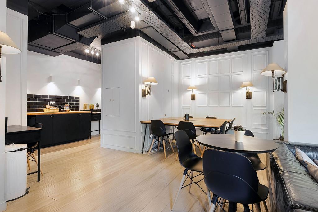 Bright and modern communal workspace featuring ...
