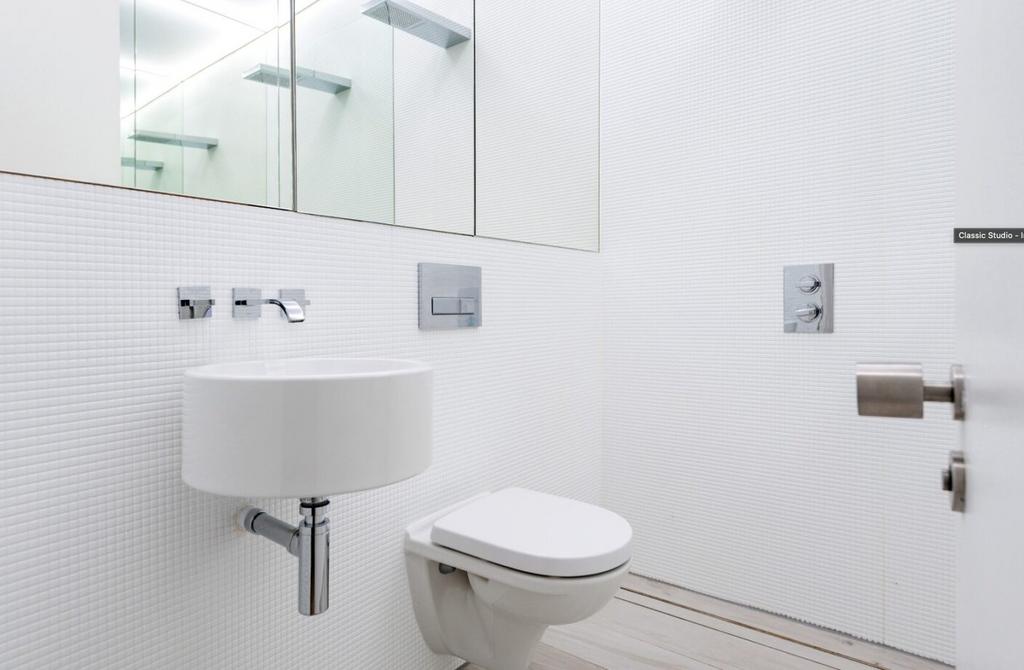 A modern and clean bathroom featuring a shower ...