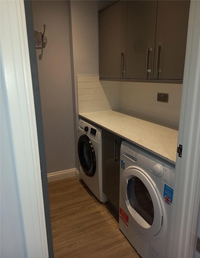 A neat and well-organized utility room featurin...