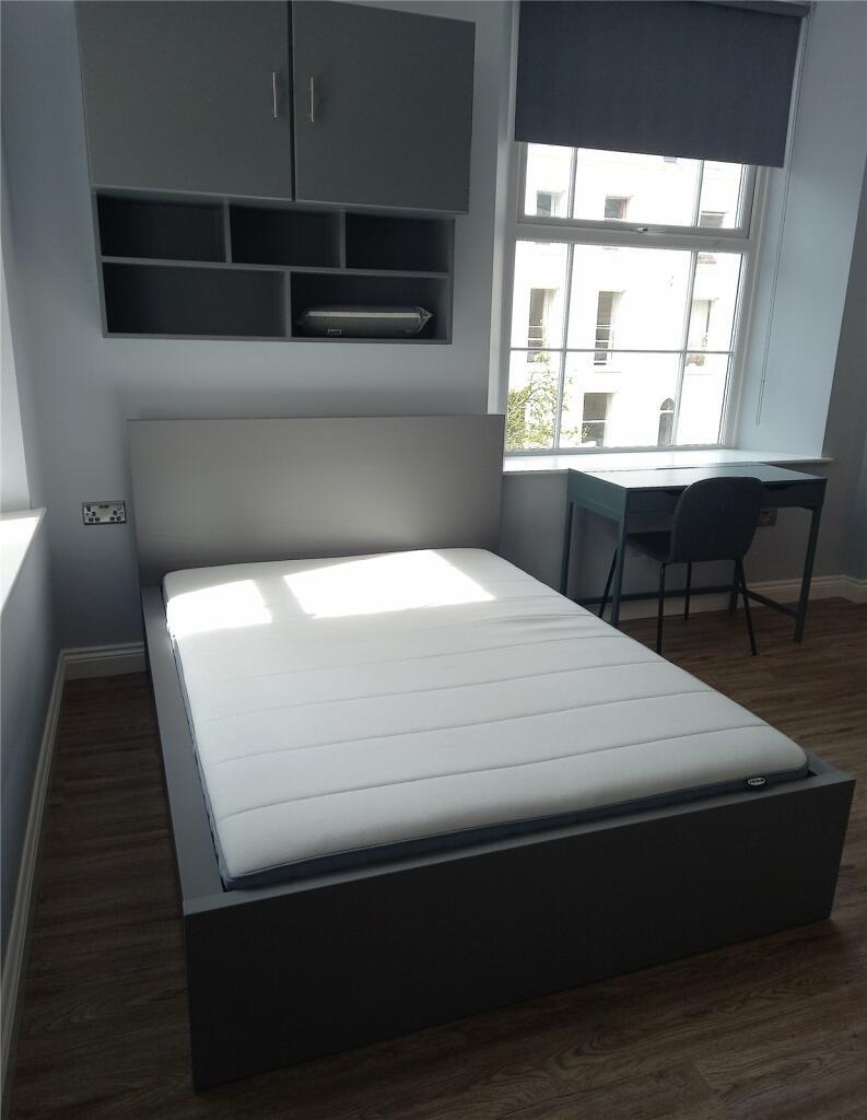 A modern double bedroom featuring a comfortable...