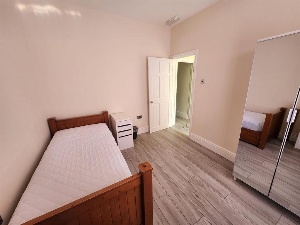 A bright and clean student bedroom featuring a ...