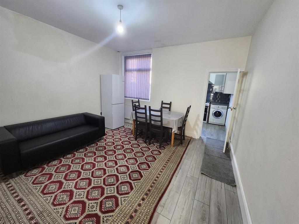 A spacious and well-lit living room featuring a...