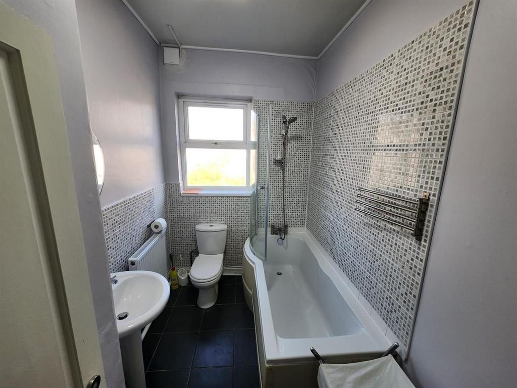 A well-maintained bathroom with a bathtub, mode...