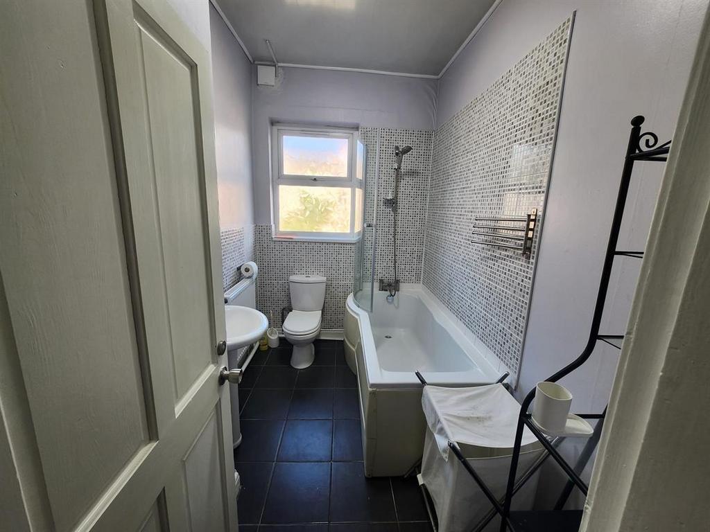 A bright, well-maintained bathroom featuring a ...