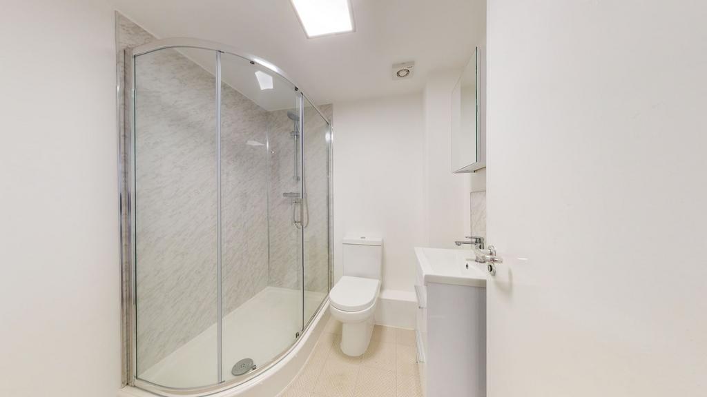 A clean and bright modern bathroom with a corne...
